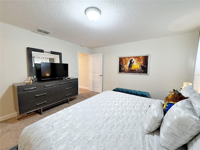 carpeted bedroom with a textured ceiling