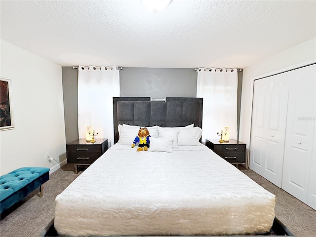 carpeted bedroom with a closet and a textured ceiling