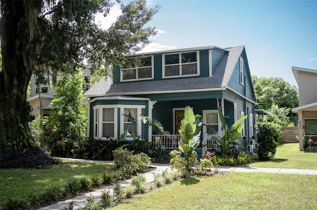 view of front facade with covered porch and a front yard