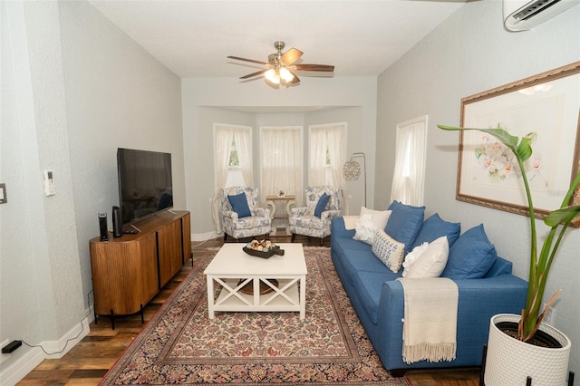 living room with ceiling fan, a wall mounted air conditioner, and dark hardwood / wood-style floors