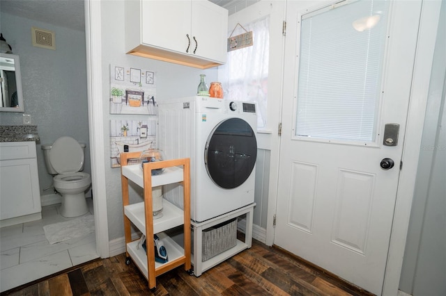 laundry room featuring dark hardwood / wood-style floors and washer / dryer