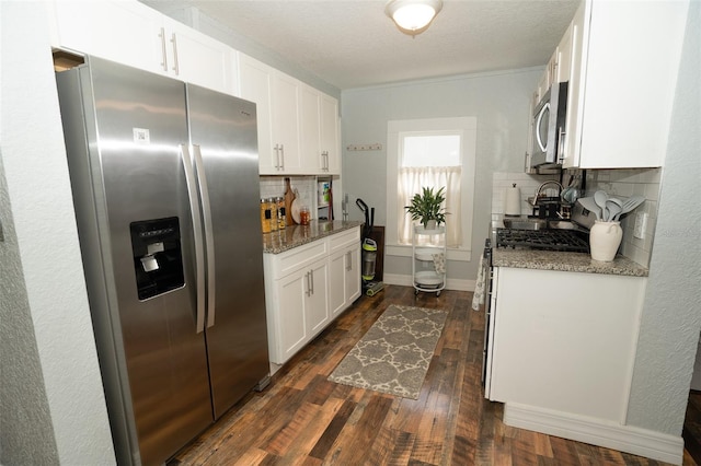 kitchen featuring stainless steel appliances, dark hardwood / wood-style floors, stone countertops, decorative backsplash, and white cabinets