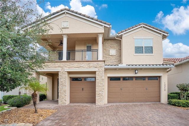 view of front of home featuring a garage and a balcony