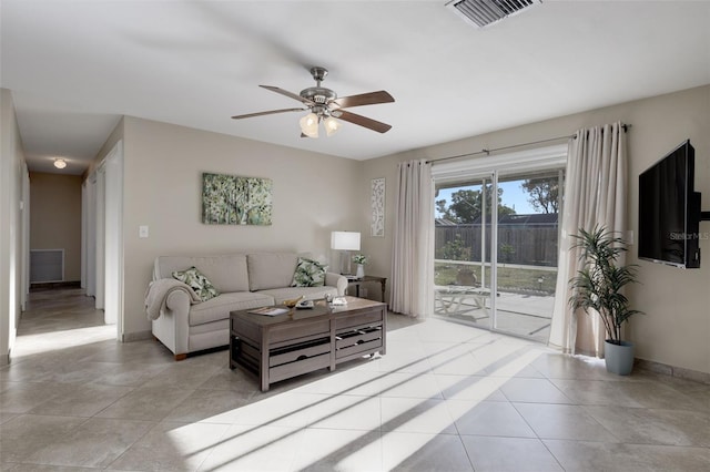 tiled living room with ceiling fan