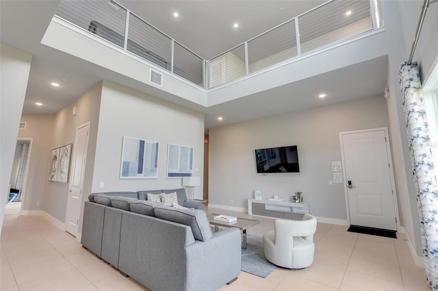 tiled living room featuring a towering ceiling