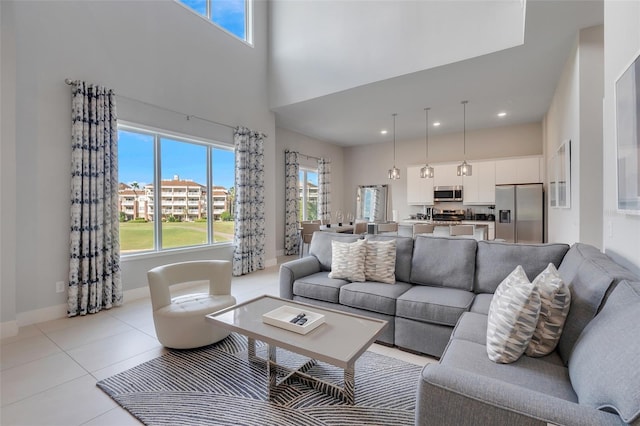 living room featuring a towering ceiling and light tile patterned flooring