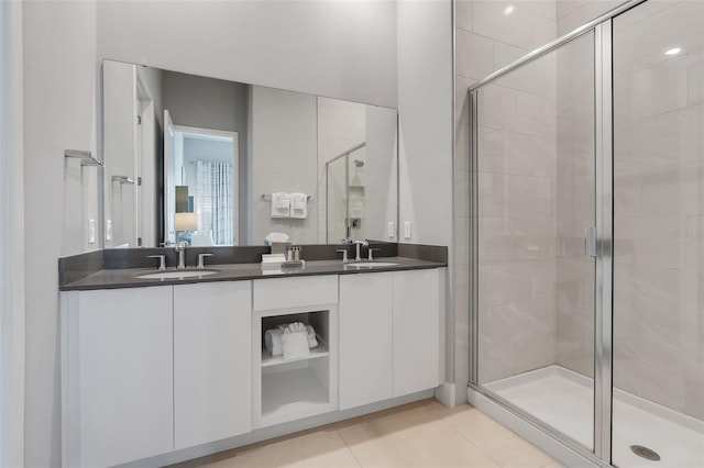 bathroom featuring vanity, tile patterned flooring, and a shower with door