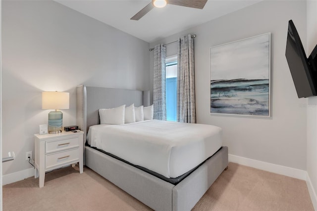 bedroom featuring light carpet and ceiling fan