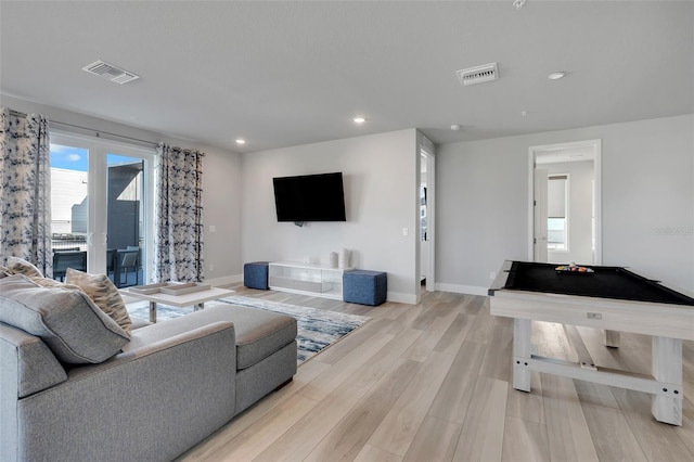 living room featuring pool table and light hardwood / wood-style floors