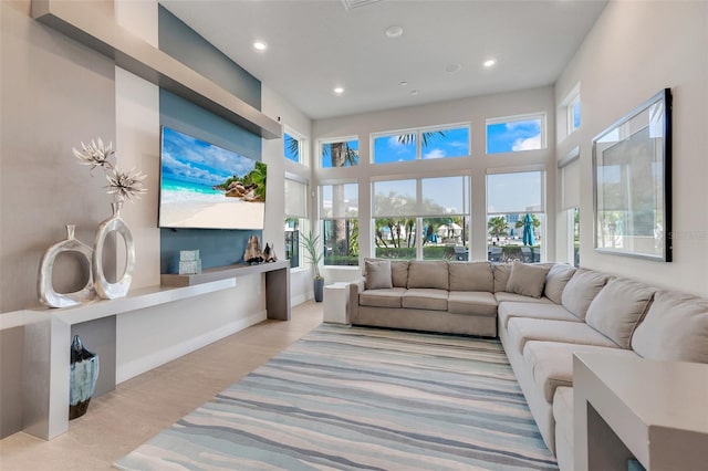 living room featuring a high ceiling and plenty of natural light