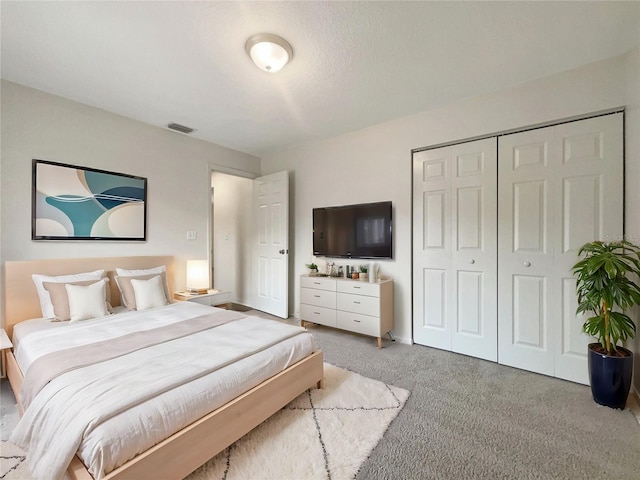 carpeted bedroom with a closet