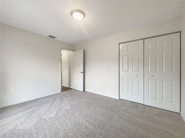 unfurnished bedroom featuring a closet and carpet floors