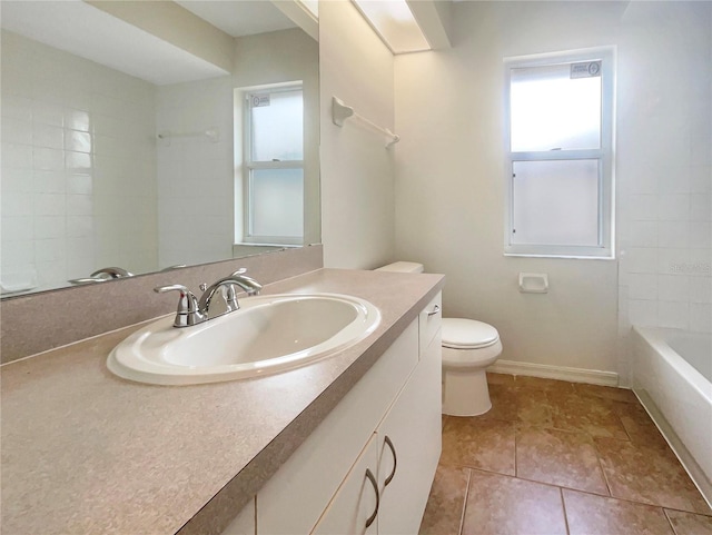 bathroom featuring toilet, vanity, and tile patterned flooring