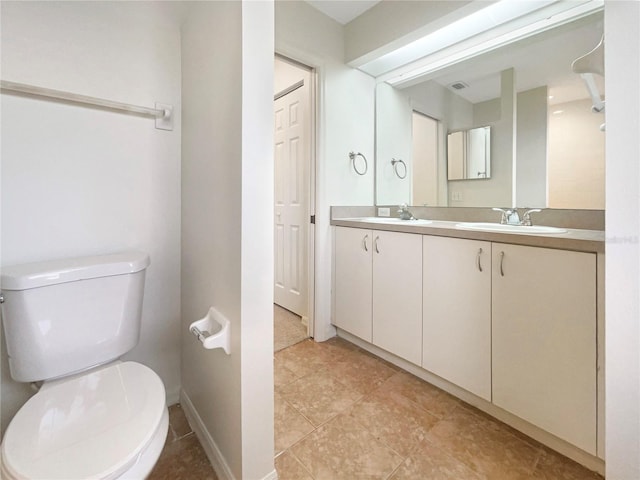 bathroom featuring tile patterned floors, vanity, and toilet