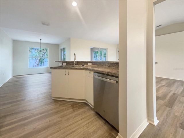 kitchen featuring white cabinetry, sink, hanging light fixtures, light hardwood / wood-style flooring, and dishwasher