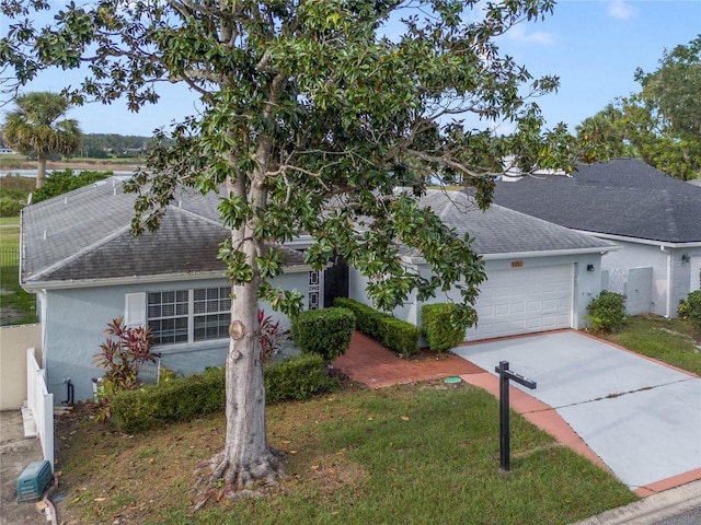 single story home with a garage and a front lawn