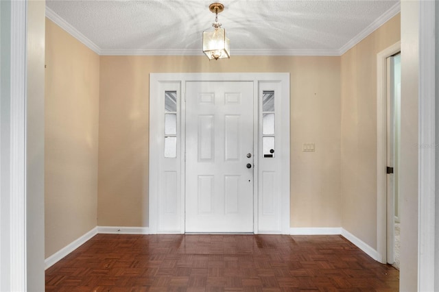 entrance foyer with dark parquet floors, a textured ceiling, and ornamental molding