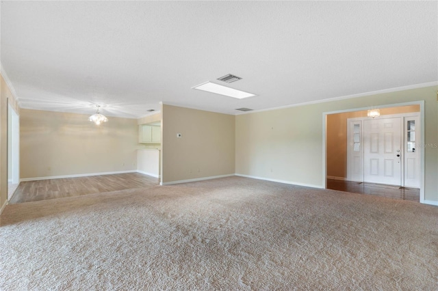 carpeted spare room featuring a textured ceiling and ornamental molding