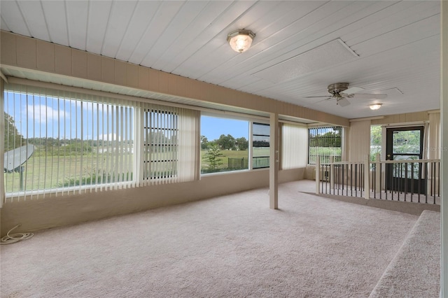 unfurnished sunroom with ceiling fan