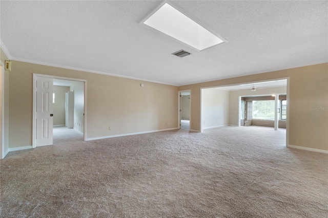 carpeted empty room featuring a textured ceiling and ornamental molding