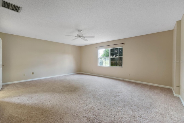 unfurnished room with ceiling fan, a textured ceiling, and carpet flooring