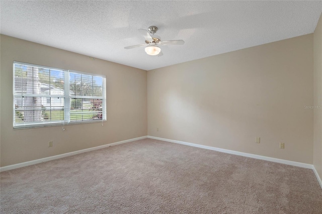 carpeted empty room featuring a textured ceiling and ceiling fan