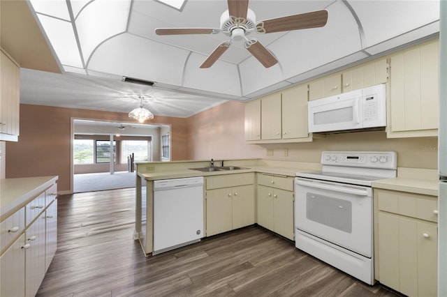 kitchen with dark hardwood / wood-style flooring, cream cabinets, sink, white appliances, and decorative light fixtures