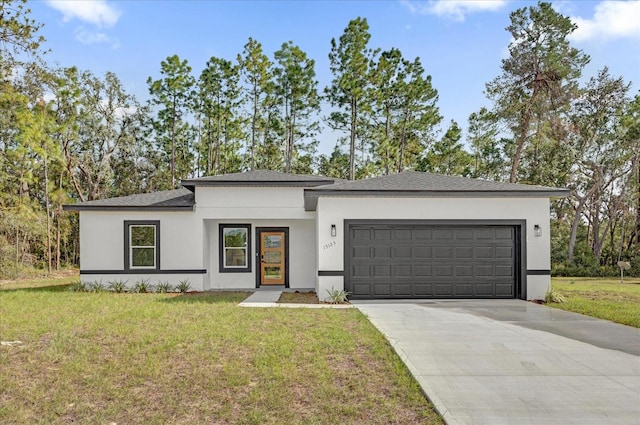 view of front of property with a front lawn and a garage