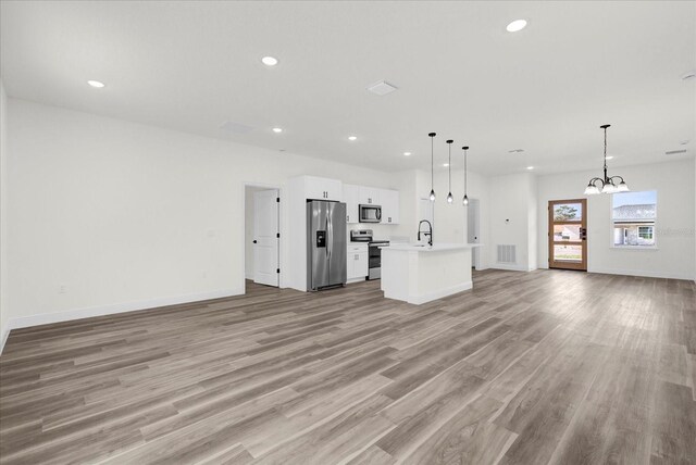 15123 SW 61st Court Rd, Ocala, FL 34473 - unfurnished living room with light wood-style flooring, a chandelier, baseboards, and recessed lighting