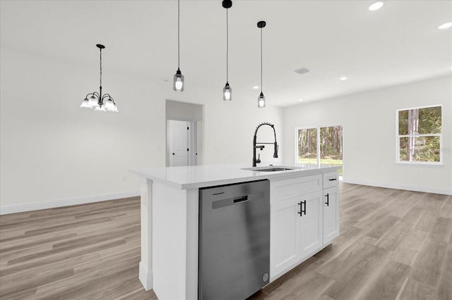 kitchen featuring dishwasher, an island with sink, pendant lighting, sink, and white cabinetry