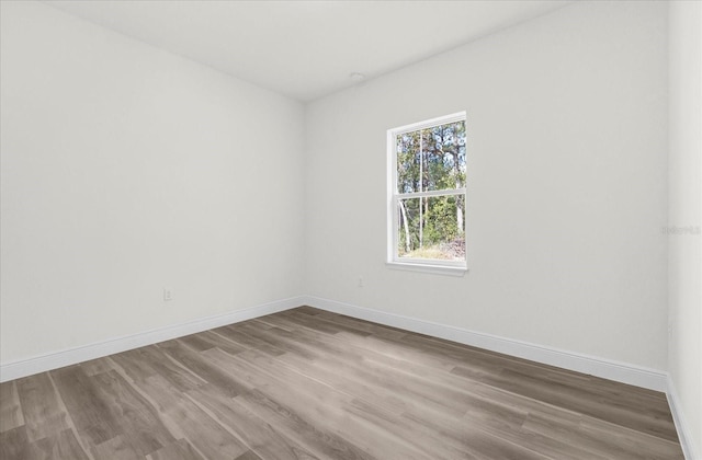 unfurnished room with hardwood / wood-style floors