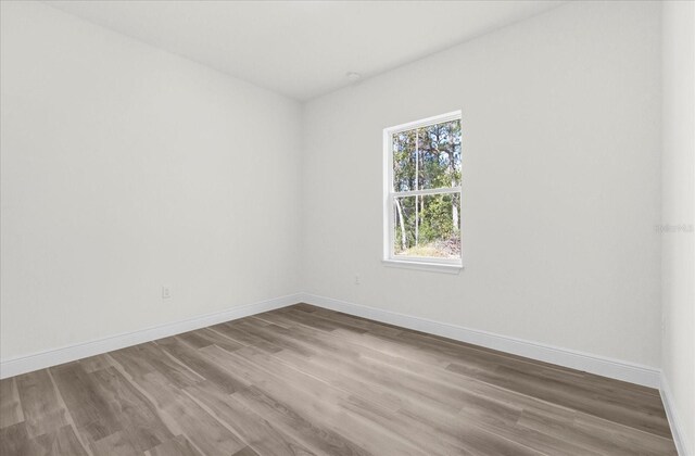 15123 SW 61st Court Rd, Ocala, FL 34473 - spare room featuring wood finished floors and baseboards