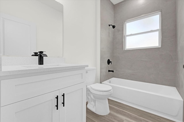 full bathroom with toilet, shower / bath combination, wood-type flooring, and vanity