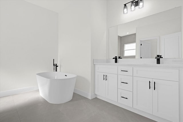 15123 SW 61st Court Rd, Ocala, FL 34473 - bathroom featuring baseboards, double vanity, and a freestanding bath