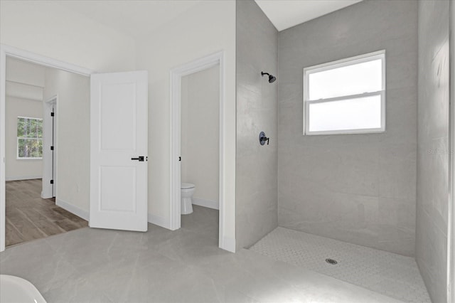 15123 SW 61st Court Rd, Ocala, FL 34473 - bathroom featuring tiled shower, toilet, and baseboards