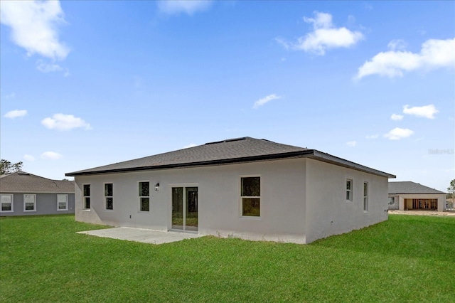 back of house with a patio, stucco siding, and a yard