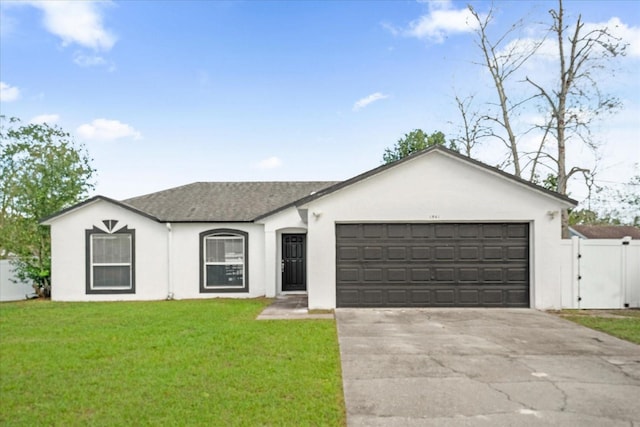 ranch-style home featuring a garage and a front yard