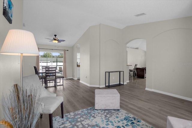 living room featuring ceiling fan, wood-type flooring, and lofted ceiling