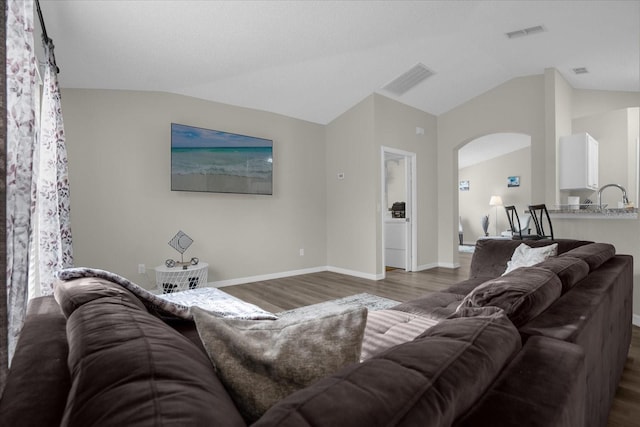 living room featuring dark hardwood / wood-style floors and lofted ceiling