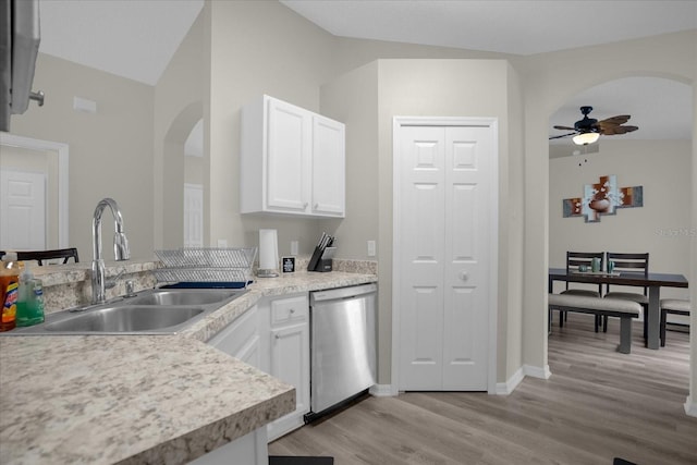 kitchen featuring sink, light hardwood / wood-style floors, white cabinets, dishwasher, and lofted ceiling