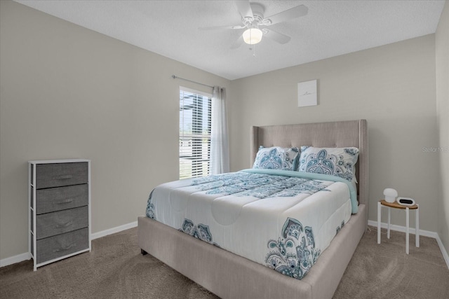 carpeted bedroom with ceiling fan and a textured ceiling