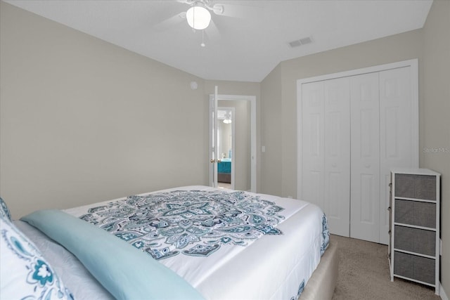 carpeted bedroom featuring a closet and ceiling fan