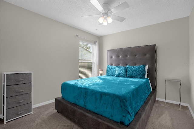 bedroom featuring ceiling fan, a textured ceiling, and carpet floors