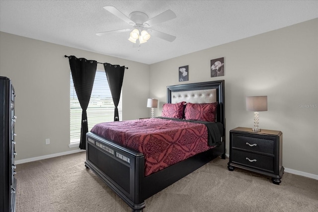 carpeted bedroom with ceiling fan and a textured ceiling