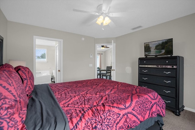 bedroom with a textured ceiling, carpet floors, ceiling fan, and connected bathroom