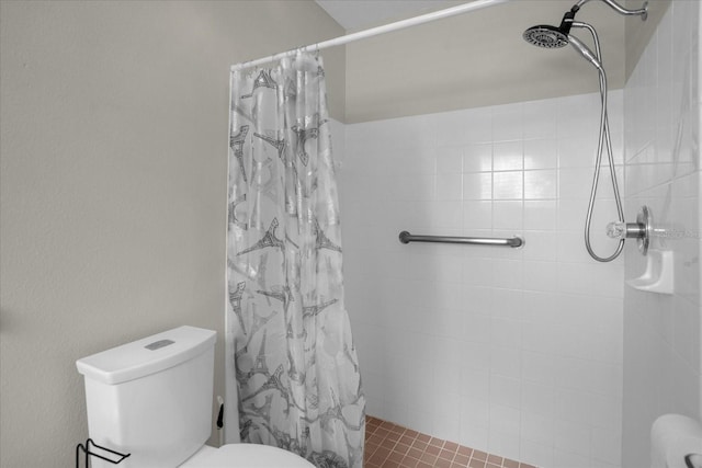 bathroom featuring a shower with curtain, tile patterned floors, and toilet