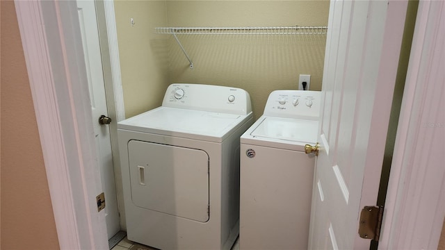 clothes washing area featuring independent washer and dryer