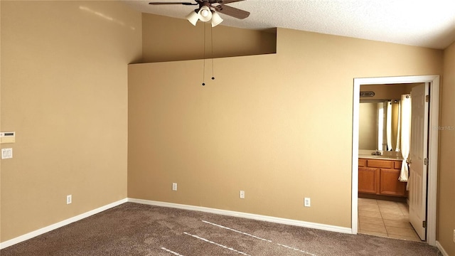 unfurnished room with light carpet, sink, ceiling fan, and lofted ceiling