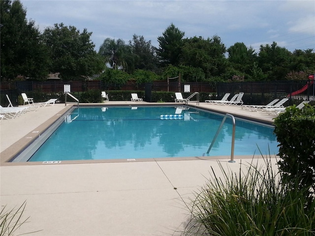 view of swimming pool with a patio area