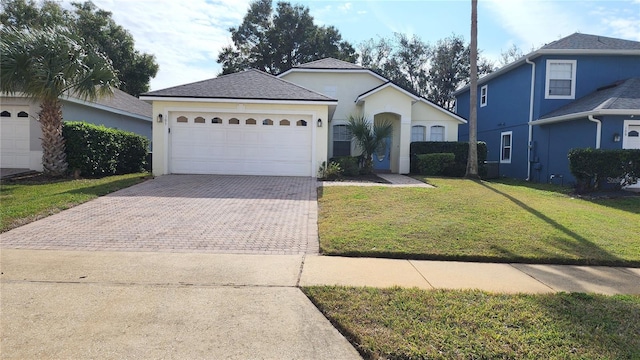 view of front of house with a front lawn and a garage